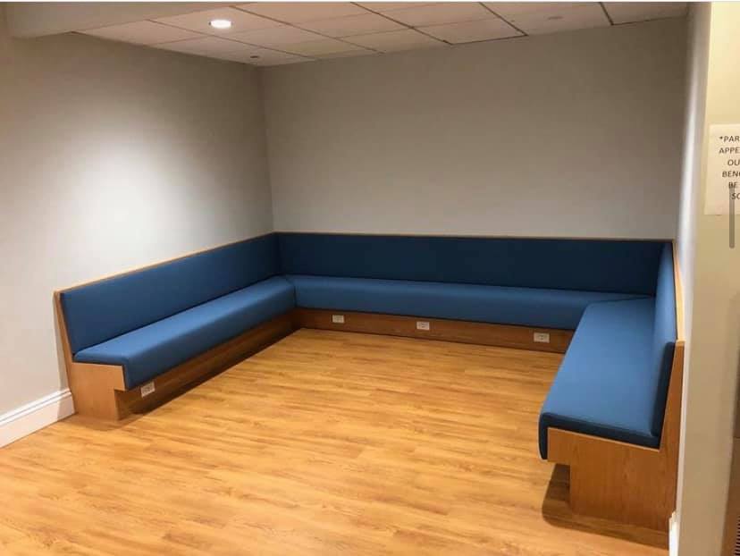 U-shaped upholstered bench seating installed by Melmar in a commercial waiting room