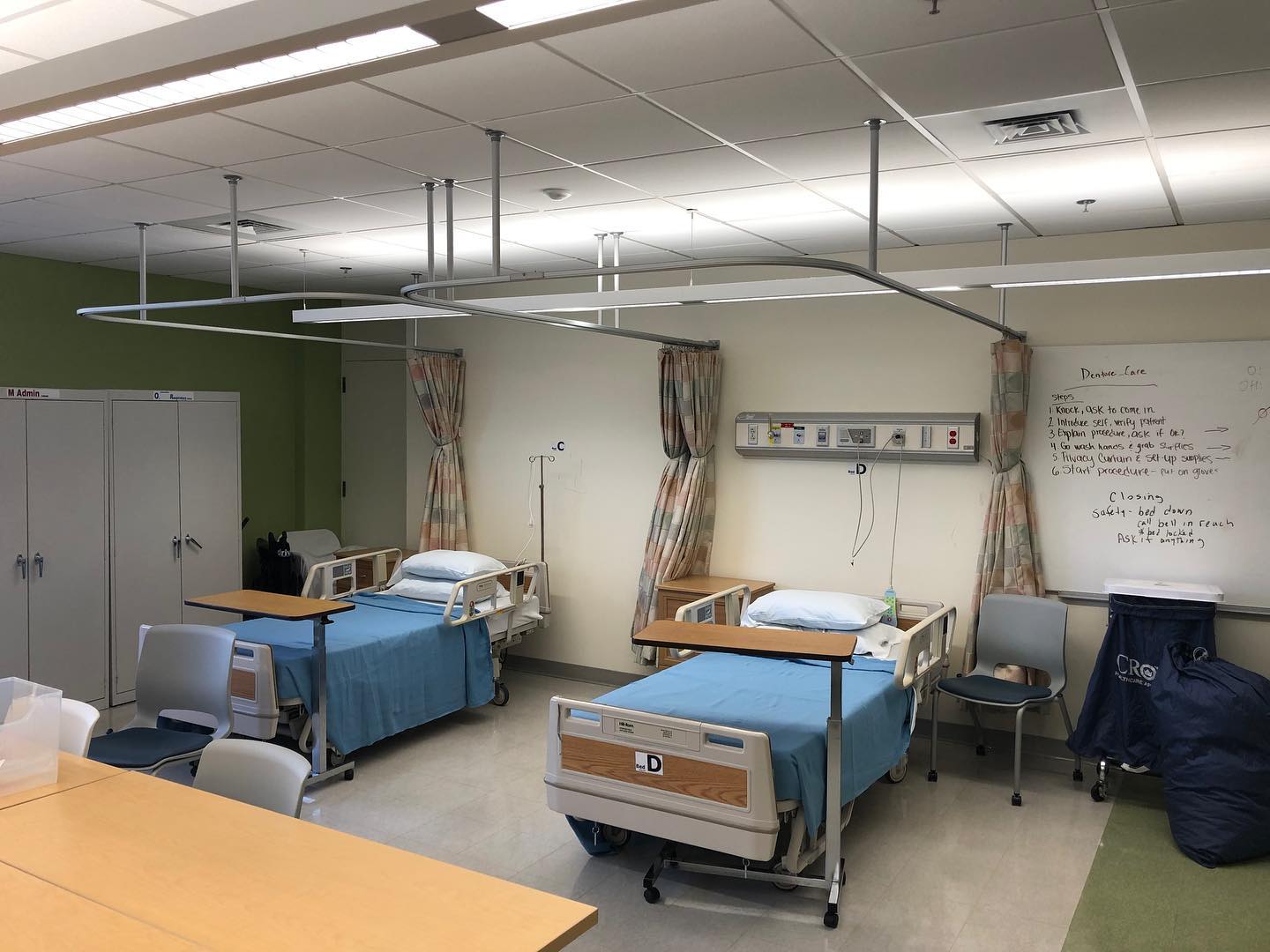 Patient bays separated by Melmar cubicle curtains on ceiling-mounted tracks
