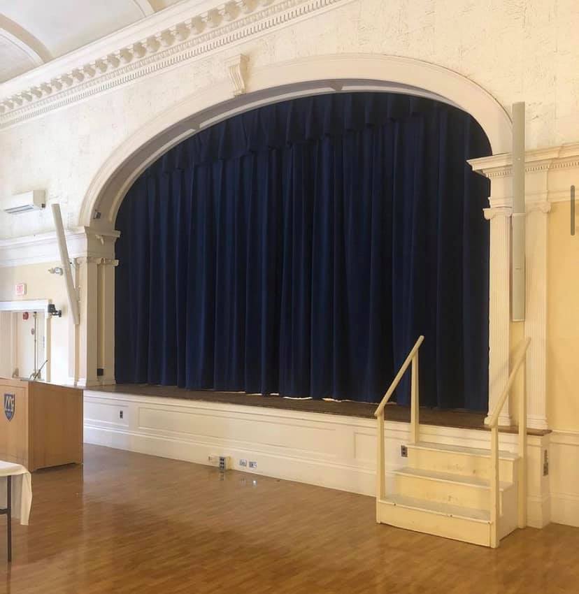 Navy stage curtain fabricated for a school auditorium