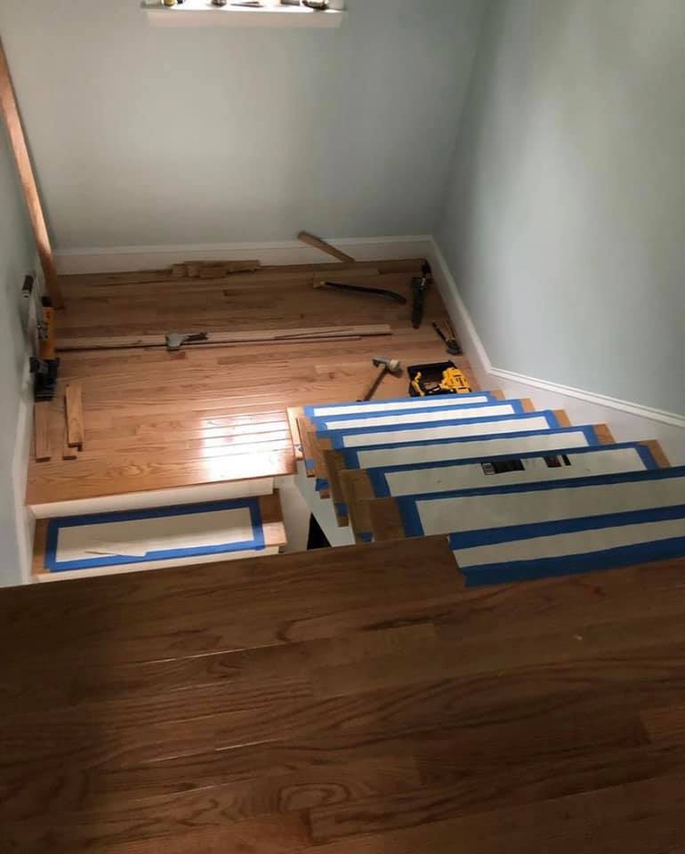 Melmar crew mid-install on a hardwood staircase