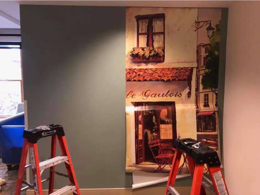 Melmar crew installing a wall mural in a care facility